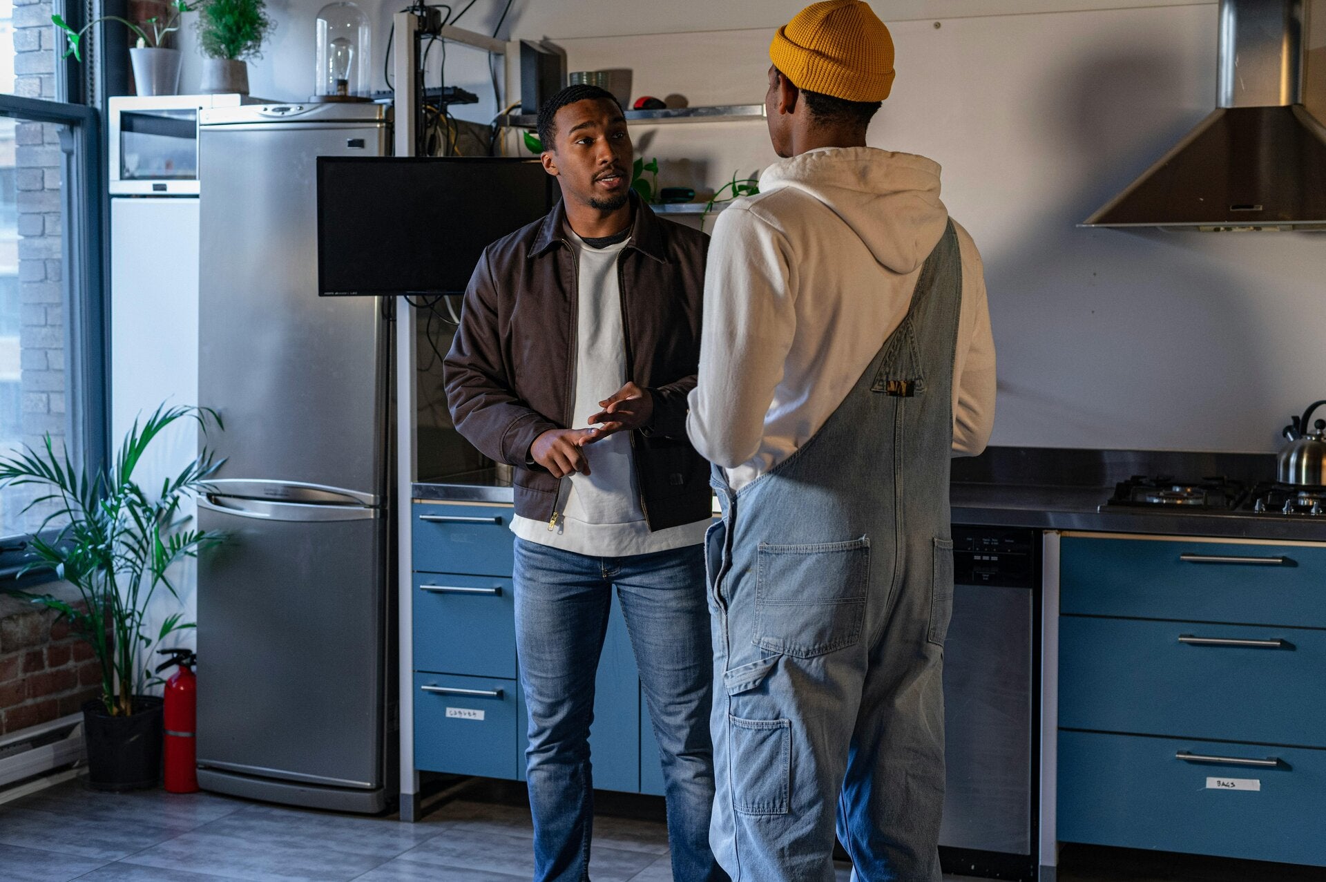 X.Q Electrical electrician discussing an electrical job with a homeowner in a Doncaster kitchen